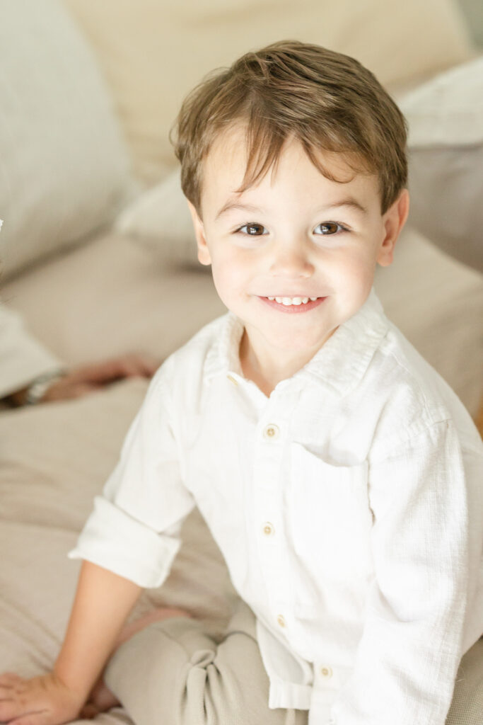 toddler boy smiling at camera houston newborn photographer