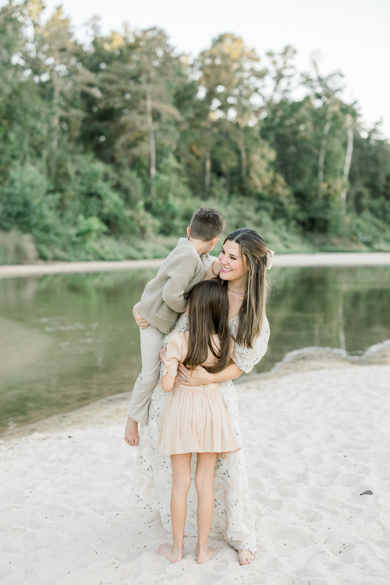 family photographer mom holding her two children, houston family photographer focusing on motherhood photography