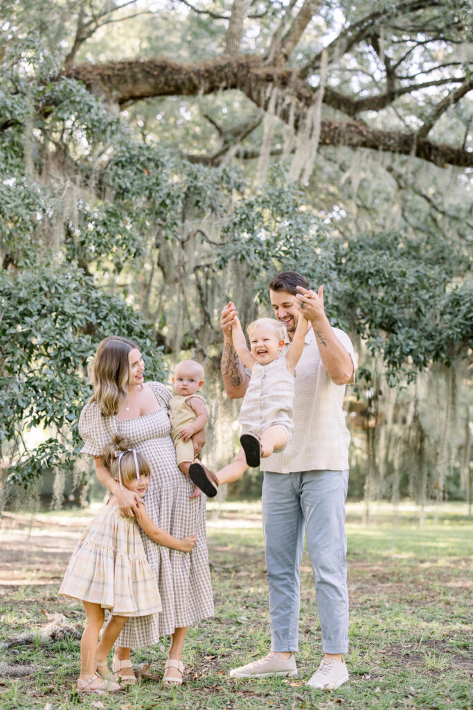 Family playing under the Spanish moss trees during a Charleston, South Carolina Family Session 