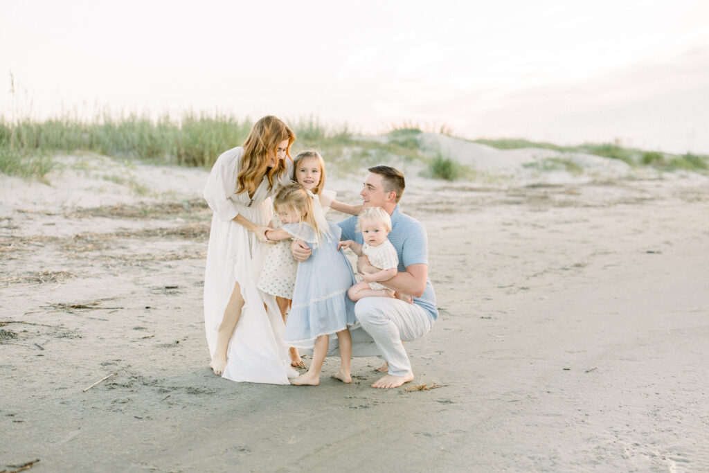 Family of 6 at the beach during sunrise for family photos in Charleston, South Carolina