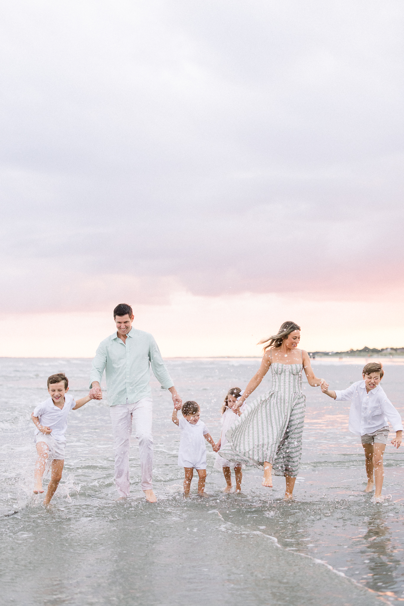 family walking in the water at the beach during a Family Session in Charleston, South Carolina
