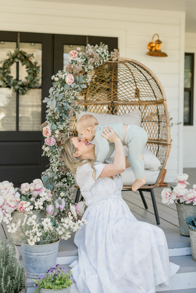 Mother and toddler son on a front porch in the spring for a motherhood mini event in Tomball, Texas. 