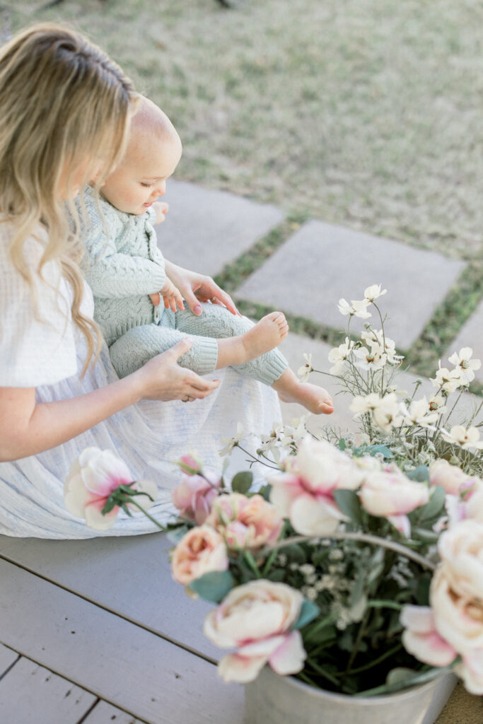 mom and son cuddled on a front porch in the spring time in Tomball during a motherhood portrait event 