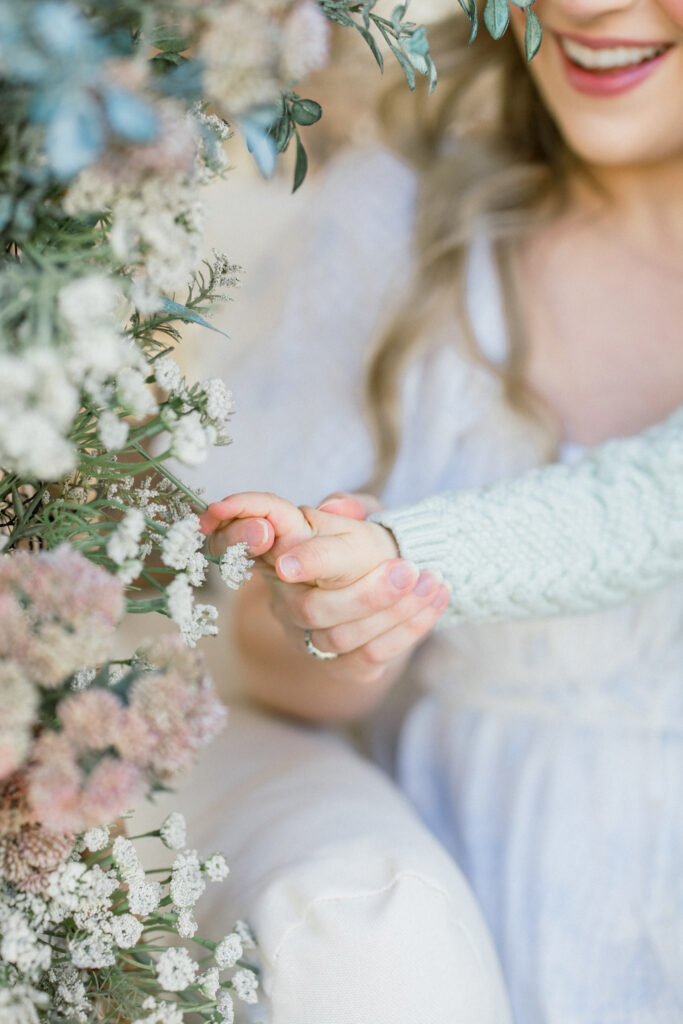 Baby touching florals for mothers day mini event in Tomball Texas in the Spring. 